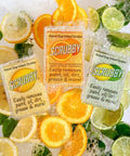 Image of Lemon, Orange, and Lemon Lime Scrubby Soaps laying on top of their respective fruit slices surrounded by soap suds.