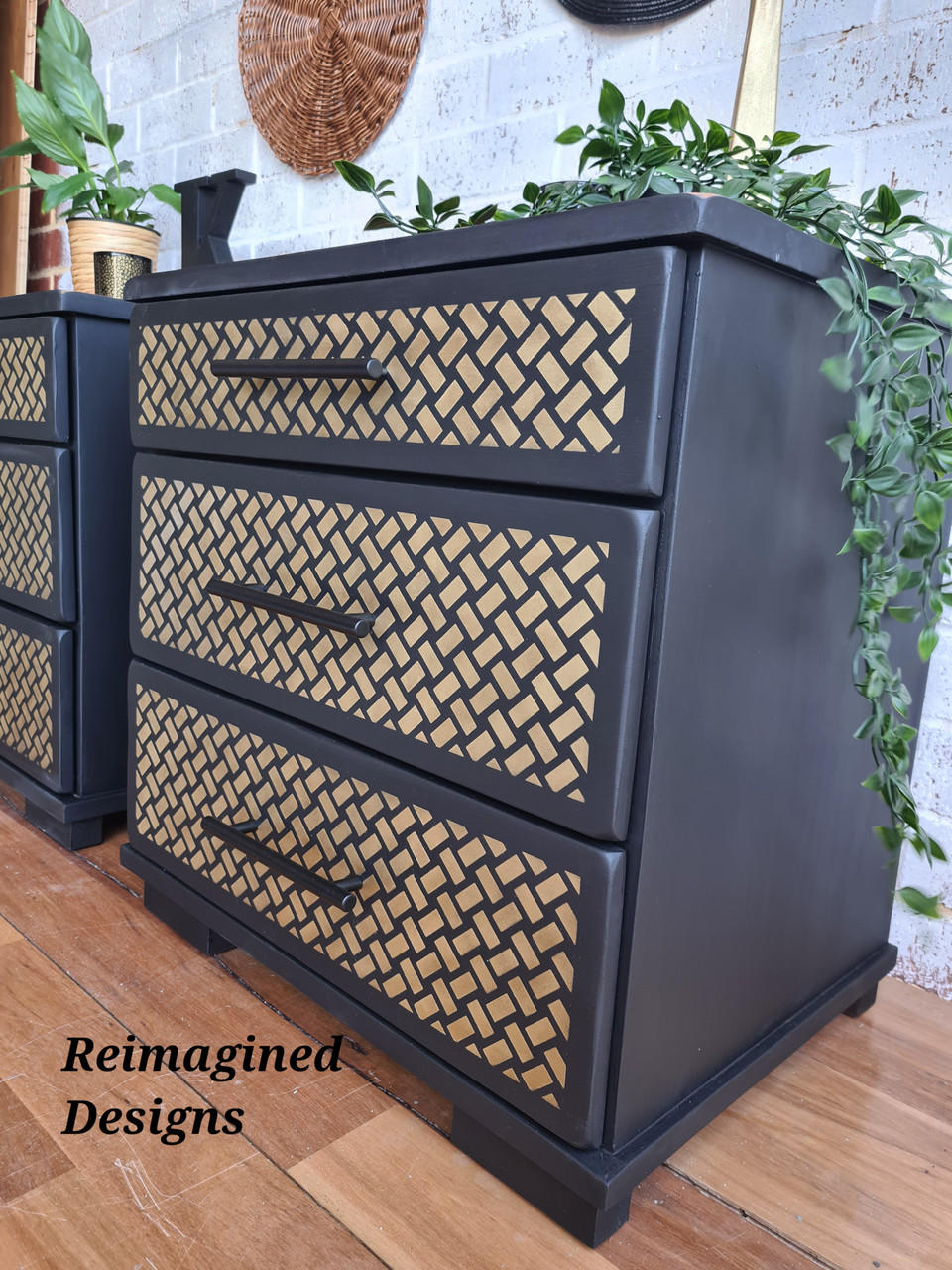 Belles and Whistles Basket Weave - Stencil,A Basket Weave design on our Premium Mylar Stencils feature a high grade material allowing for the most precise stenciling techniques and applications. Our stencils can be used on walls, furniture and more. Durable and reusable. Laser cut on 1o mil Mylar. Black bedside tables with Basket Weave - Stencil on all three drawers in gold. Staged with greenery hanging off piece with a black K in the background on top of other table.