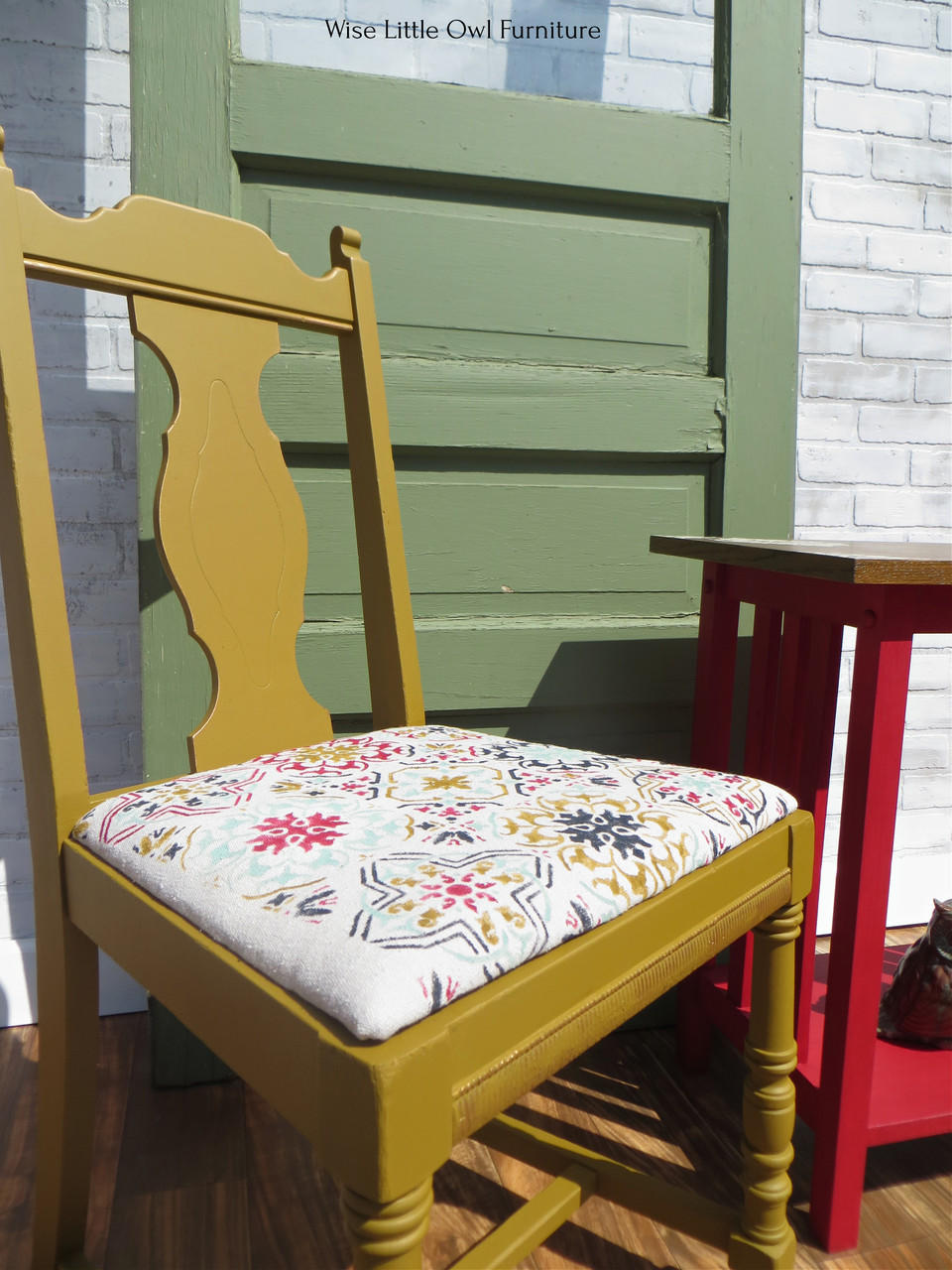 Belles and Whistles Sonoma Art Tile - Stencil provides an extra decorative touch to any project! A chair painted in a mustard yellow color and the sonoma art tiles stencil on the kitchen chair seat in various bright colors.