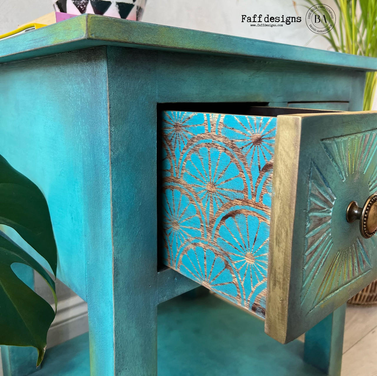 Belles and Whistles When Life Gives You Lemons - Stencil. A blue chalk painted night stand with the drawer partially open. The side of the drawer has the When Life Gives You Lemons stencil chalk painted in blue. The knob on the drawer i bronze. Greenery is on both the left and the right of the night stand. A white & black chalk painted bowl sits on top of the night stand.