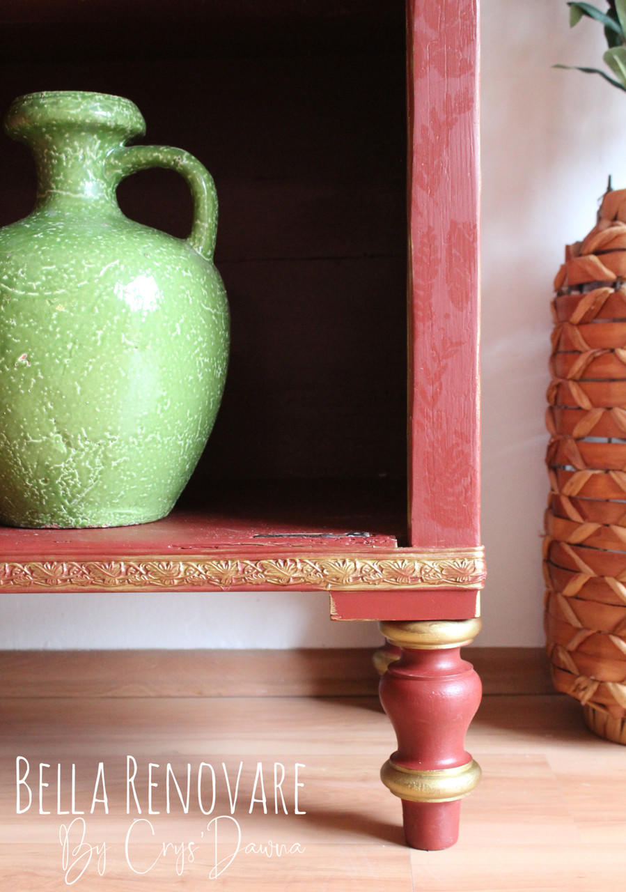 WoodUBend Trim #TR009 is the perfect mouldable embellishment for any project! The lower right corner of a red shelf that has WoodUBend applied and highlighted gold. A green vase sits on the shelf and a basket is to the right of the piece.