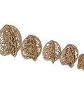 A set of five intricately carved wooden egg cutouts of varying sizes, arranged in a line from largest to smallest. Each piece features detailed floral and vine cut-out patterns.