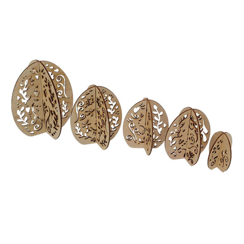 A set of five intricately carved wooden egg cutouts of varying sizes, arranged in a line from largest to smallest. Each piece features detailed floral and vine cut-out patterns.