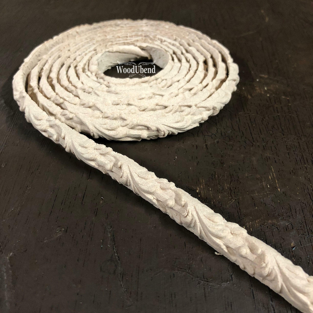 WoodUBend Trim #TR50a is the perfect mouldable embellishment for any project!  A roll of WoodUBend Trim #TR50a lying on a table, unrolling at one end.