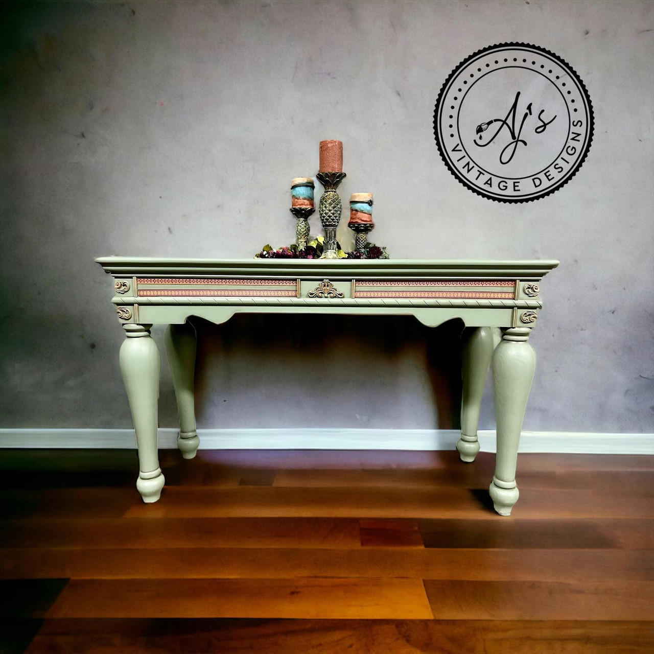 Coffee table chalk painted with Weeping Willow colored chalk paint and the Bohemian Rub On Furniture transfer on the front. Three candles are displayed on the top.