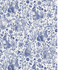 Blue and white toile pattern featuring rabbits, birds, and snails among wildflowers and grass, creating a delicate and detailed nature scene.
