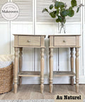 Two light wood nightstands with single drawers, styled with green potted plants on top. The background features a wicker basket and a white shuttered cabinet. A logo reads "My Little Makeovers" and the text "Au Naturel" is in the bottom right corner.