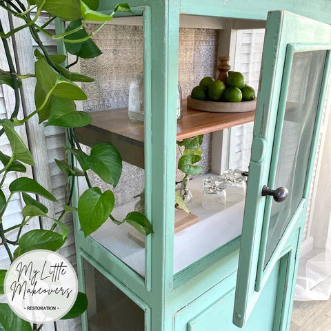Belles and Whistles Ancient Mud Cloth - A1 Rice Decoupage Paper is a simple way to visually enhance any surface of your project! Teal see through cabinet staged with tequila, limes and drink glasses. The back of the cabinet is finished with the Ancient Mud Cloth decoupage.