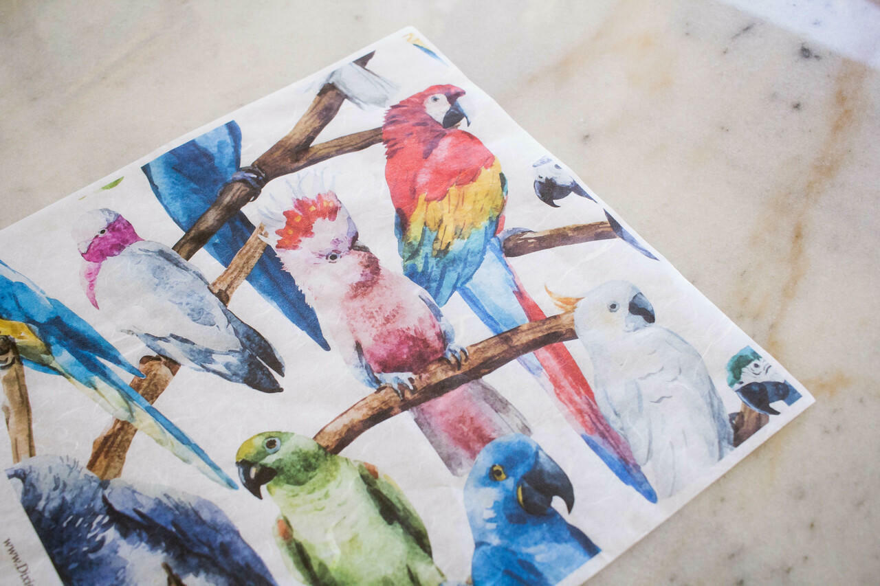 Belles and Whistles Birds - Rice Decoupage Paper is a simple way to visually enhance any surface of your project! Layout of Birds - Rice Decoupage Paper on marble table.