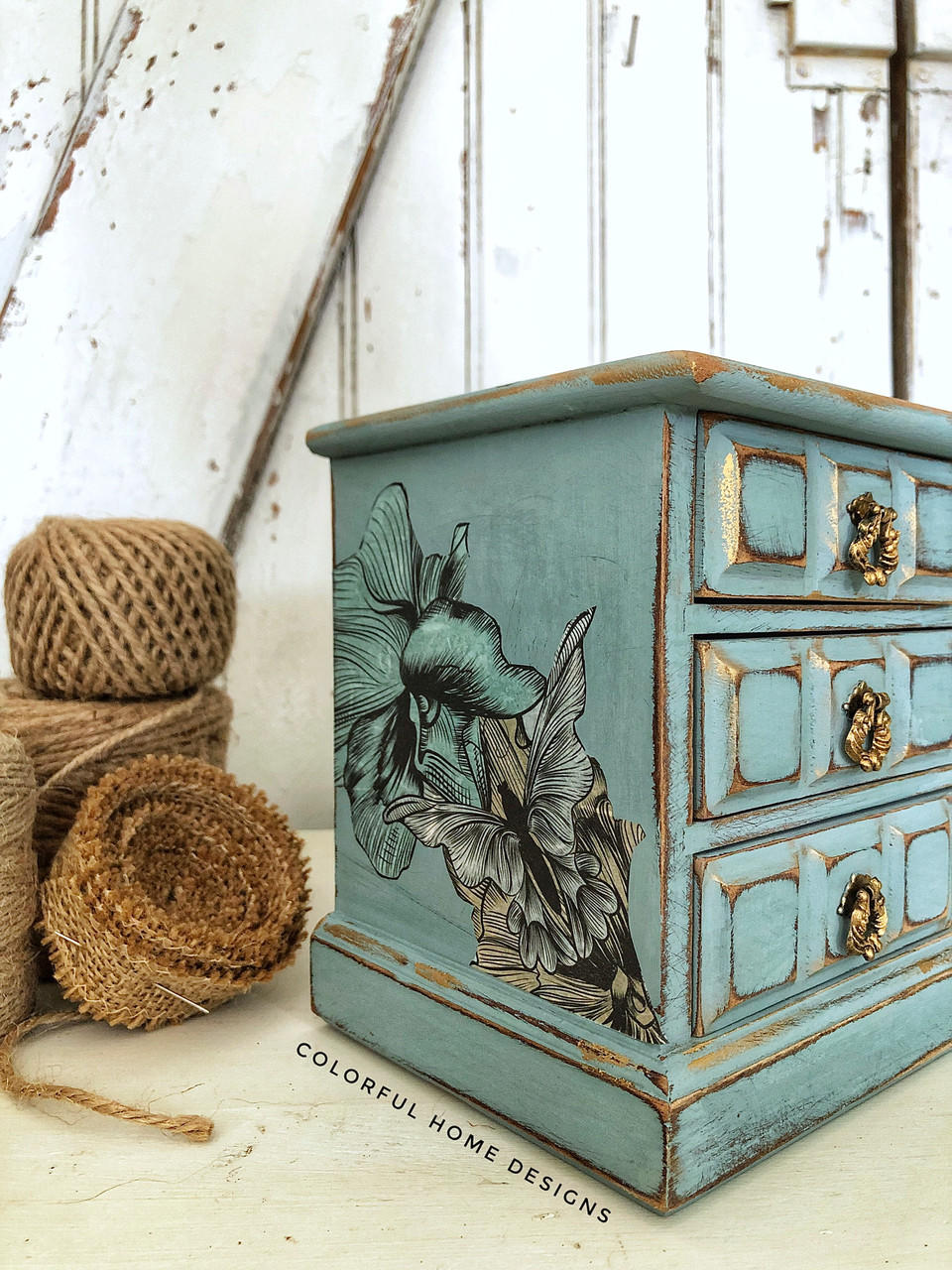 Belles and Whistles Blue and Yellow Floral - Rice Decoupage Paper is a simple way to visually enhance any surface of your project!  Vintage jewelry box painted with Chalk Mineral Paint vintage duck egg Decoupaged with Belles & Whistles Blue and yellow Floral rice paper on the side. Staged with twine on the left side.