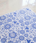 Belles and Whistles Blue Glass Ornate - Rice Decoupage Paper is a simple way to visually enhance any surface of your project! A sheet of Blue Glass Ornate - Rice Decoupage Paper staged on top of a shiny marble countertop.
