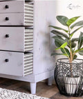 Belles and Whistles Botanical - Silkscreen Stencil provides an extra decorative touch to any project!
A dresser in a white farmhouse distressed style with opened drawers, on the side of these drawers are the Botanical - Silkscreen Stencil. Staged next to a potted plant .