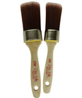 Belles and Whistles DBP Synthetic Brushes. A closeup product image displaying the Oval Medium (OM) and Oval Small (OS) synthetic brushes on a transparent background.