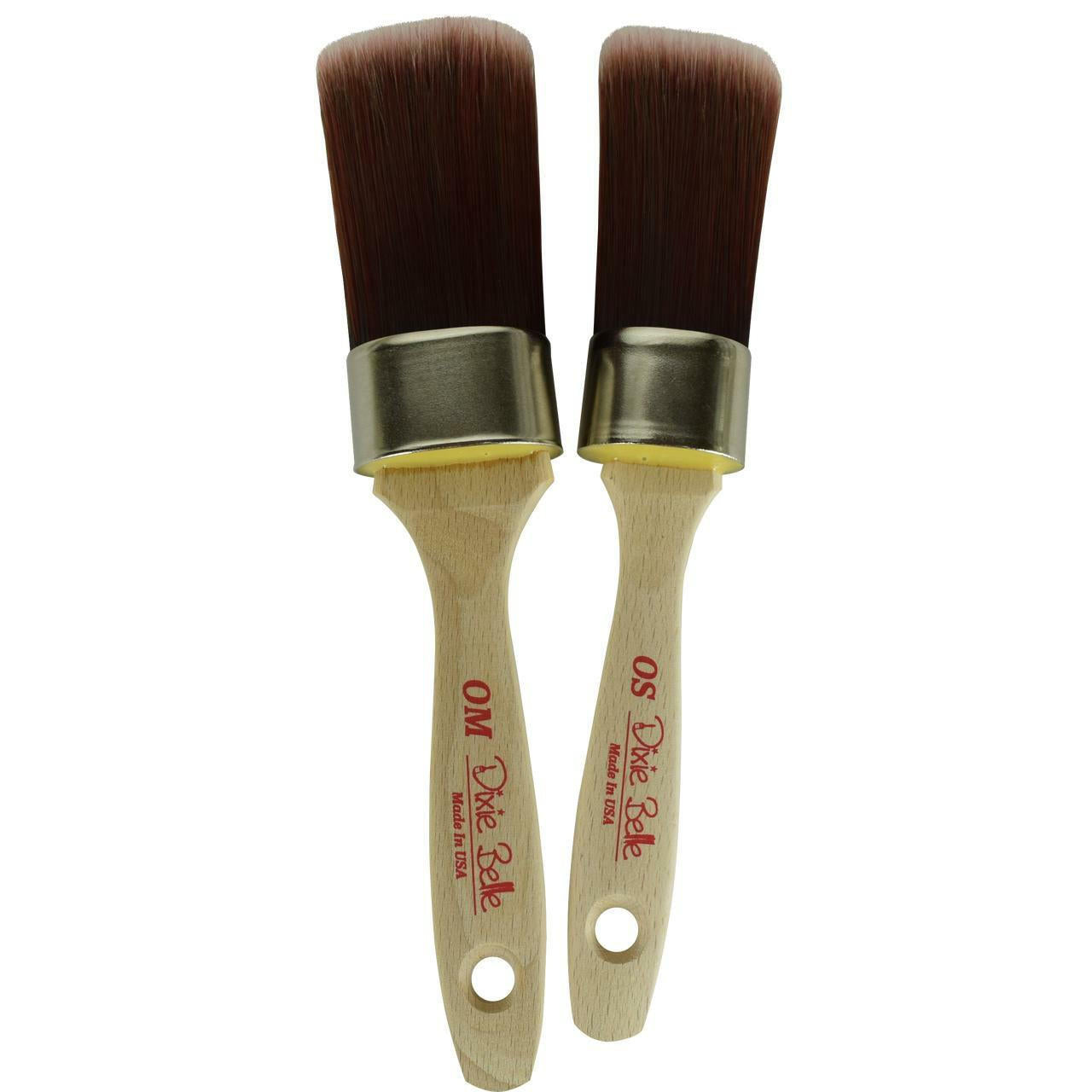 Belles and Whistles DBP Synthetic Brushes. A closeup product image displaying the Oval Medium (OM) and Oval Small (OS) synthetic brushes on a transparent background.