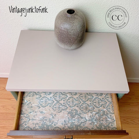Belles and Whistles Distressed Damask - A1 Rice Decoupage Paper 
This is side table with the drawer opened.  The distressed-damask decoupage is on the bottom of the drawer.  There is a brown, smooth vase on top of the side table.