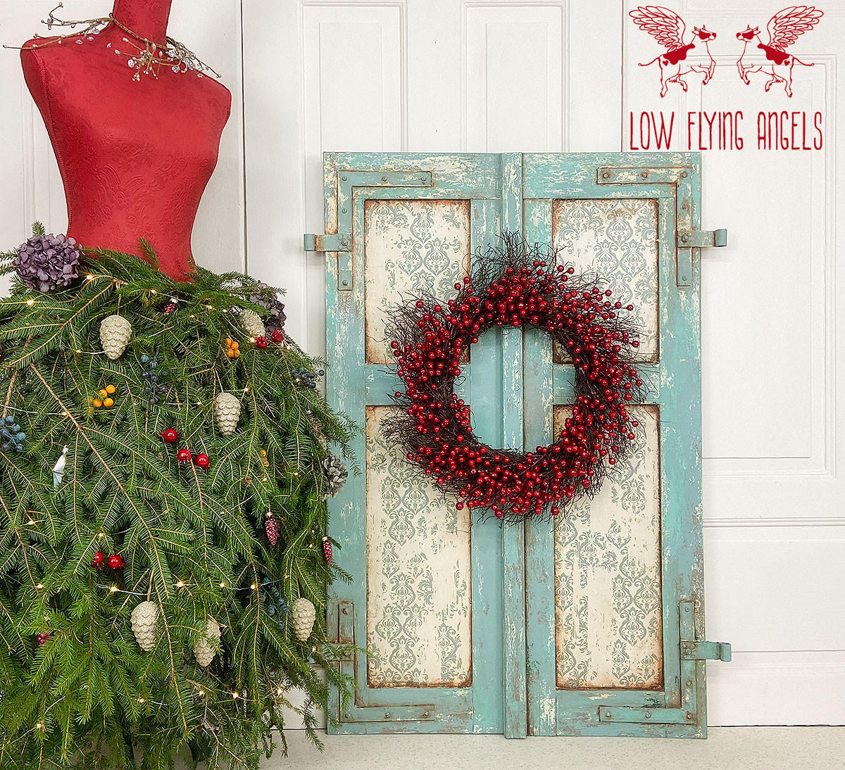 Belles and Whistles Distressed Damask - A1 Rice Decoupage Paper 
There is an old window frame that is painted with sea glass CMP and is very distressed. Where the windows would be, there is distressed-damask decoupage.  There is a dried, cranberry wreath attached to the window frame.  To the left of the window frame is a read mannequin.  As here skirt there are evergreen sprigs with colorful, plastic berries, white pinecones and a purple flower as decorations