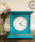 Belles and Whistles Dixie Shine 
Antique wooden clock painted a bright blue with Dixie shine in gold around the woodwork.