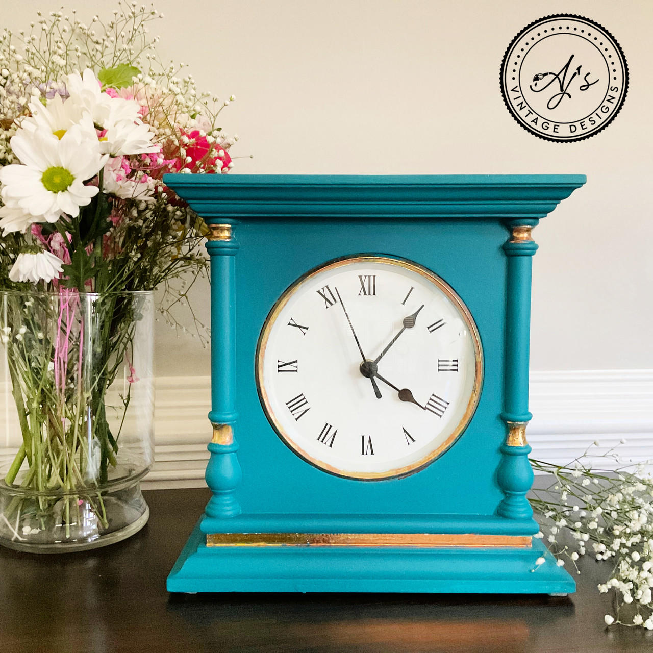 Belles and Whistles Dixie Shine 
Antique wooden clock painted a bright blue with Dixie shine in gold around the woodwork.