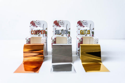 Belles and Whistles Dixie Shine 
Three rolls of Dixie Shine in each color with their appropriate packaging behind each roll. Staged on a white background.