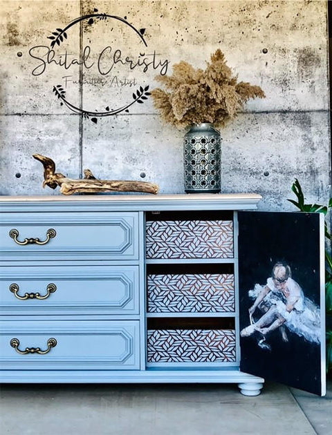 Belles and Whistles Enchanted Garden - Stencil provides an extra decorative touch to any project! Light blue painted dresser with gold handles. Floral Ballerina A1 Rice Decoupage Paper applied to the inside of the cabinet door. Enchanted Garden stencil design applied inside on the sliding drawer fronts. Staged with a large piece of driftwood and silver metal vase on top.