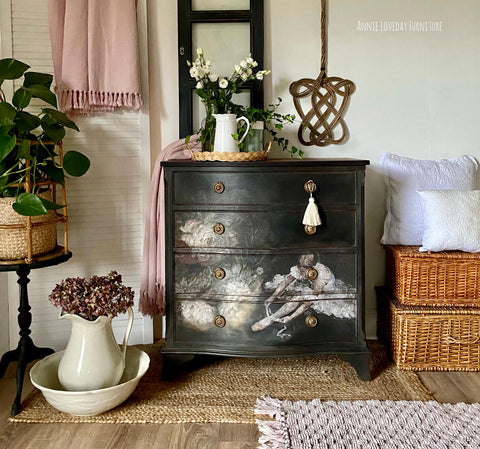 Belles and Whistles Floral Ballerina - A1 Rice Decoupage Paper is a simple way to visually enhance any surface of your project!
Black dresser with bronze hardware using the Floral Ballerina - A1 Rice Decoupage Paper on the last three drawers of piece . Staged with a tassel hanging off the top drawer.