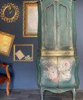 Belles and Whistles Floral Ballerina - A1 Rice Decoupage Paper is a simple way to visually enhance any surface of your project!
Tall green wardrobe with the middle drawer accented gold. Bottom piece of wardrobe has Floral Ballerina - A1 Rice Decoupage Paper  on door panels.
