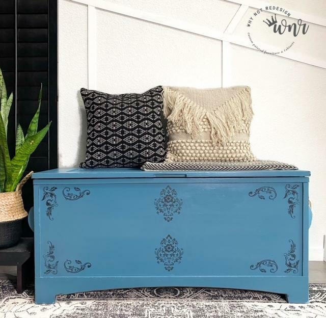 Belles and Whistles Floral - Silkscreen Stencil provides an extra decorative touch to your project!
A blue chest with the Floral - Silkscreen Stencil on the front panel staged with a white and black decorative pillows.