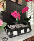 Belles and Whistles Geometric Moderne - Stencil provides an extra decorative touch to any project! Jewelry box painted in white and black with Geometric Moderne - Stencil used on top. Staged around piece is two pink orchid in blank planters Infront of black wall.