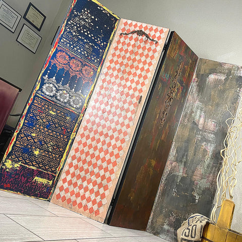 Belles and Whistles Harlequin - Stencil provides an extra decorative touch to any project!
This picture is of a 4-panel, china wall.  Two of the panels are decoupaged in a Marrakesh theme.  The second panel is stenciled with a Harlequin design.  The colors are orange and white.  The 4th panel is painted is an olive green, and dark green.  The paint doesn't cover the entire panel.  It is very streaky and shabby looking.  To the left, on the white wall are 3, framed certificates and a red, leather chair back.