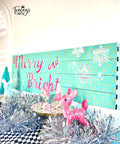 Belles and Whistles Holiday Joy - Stencil provides an extra decorative touch to any project!
A blue Sign with Holiday Joy Stencil "MERRY AND BRIGHT" and Retro Lattice Stencil in the background. Staged in front of the sign is silver tinsels and figurines of rednosed reindeer.