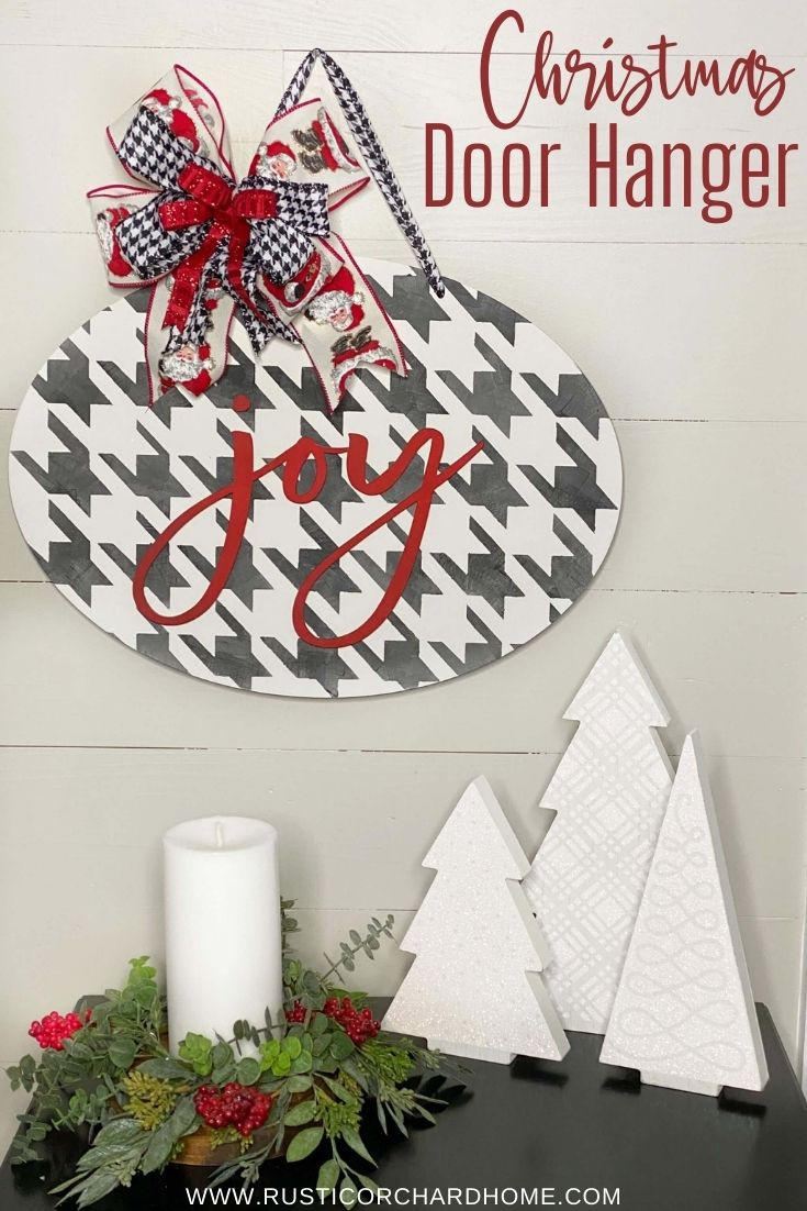 Belles and Whistles Houndstooth - Stencil provides an extra decorative touch to any project!
A white sign with Houndstooth - Stencil in black with the words "JOY" in red. Staged on the sign is a red and checkered ribbons with a Santa Claus ribbon as well tied together into a bow. Under the piece are two tree stands, along with a white candle and a wreath around candle.