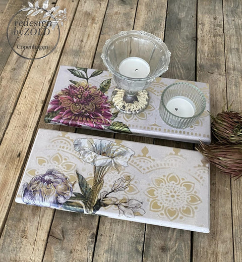 Belles and Whistles Lotus Bloom - Stencil provides an extra decorative touch to any project!
White coasters with Lotus Bloom - Stencil using gold paint. Staged with two small glass candle holders.