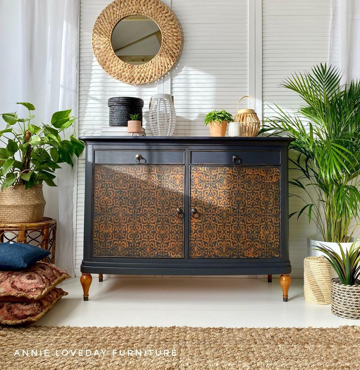 Belles and Whistles Morocco - Stencil provides an extra decorative touch to any project! Black chalk painted cabinet with Morocco stencil painted on the doors. Staged with Potted plants and a wicker mirror on the wall.