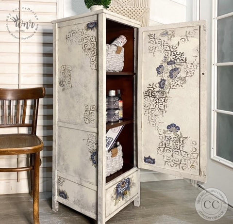 Belles and Whistles Morocco - Stencil provides an extra decorative touch to any project! White distressed chalk painted laundry cabinet with Morocco Stencil and lotus rub on transfers. Staged with Baskets and Terra clay paint.