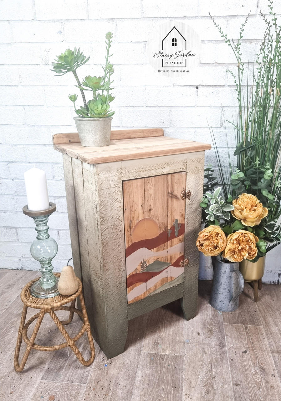 Belles and Whistles Mudcloth - Stencil provides an extra decorative touch to any project! Neutral chalk painted side table with a sunset painted on the front and raised stencil painted on it. Staged with florals and plants.