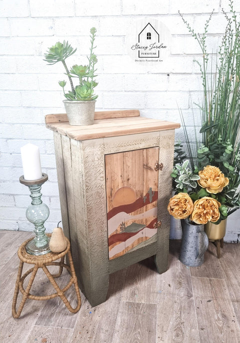 Belles and Whistles Mudcloth - Stencil provides an extra decorative touch to any project! Neutral chalk painted side table with a sunset painted on the front and raised stencil painted on it. Staged with florals and plants.