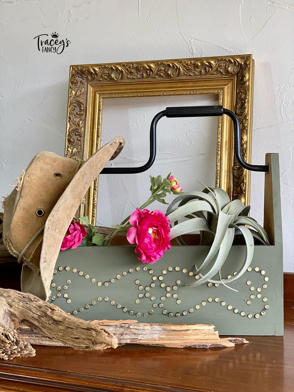 Belles and Whistles Nailhead Trim - Stencil provides an extra decorative touch to any project! Green Chalk Painted wood tool box with Nailhead trim stencil painted on. Staged with a cowboy hat, some plants and a piece of wood.