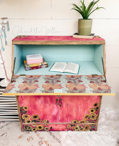 Belles and Whistles Native Rose - A1 Rice Decoupage Paper is a simple way to visually enhance any surface of your project! Red Chalk Painted secretary cabinet with sunflower transfers and teal inside with native rose decoupage. Staged with books and a plant.
