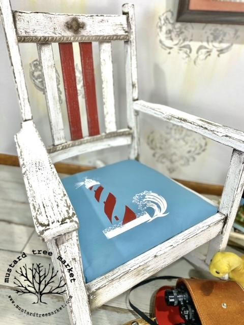 Belles and Whistles Nautical - Silkscreen Stencil provides an extra decorative touch to any project! Weathered white chalk painted chair with a blue painted seat with lighthouse stencil painted on.