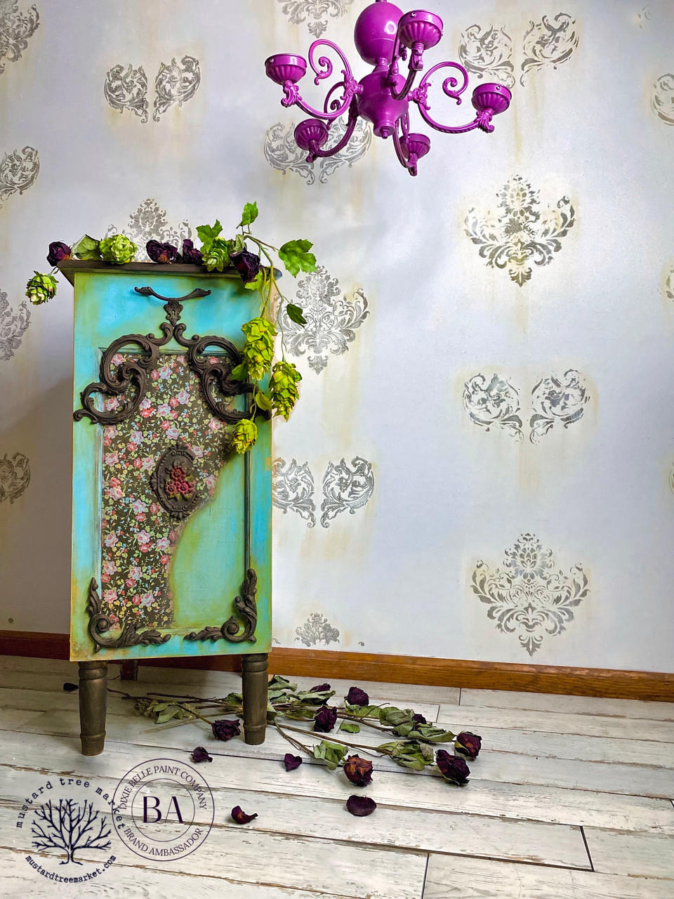 Belles and Whistles Peony Pattern - A1 Rice Decoupage Paper is a simple way to visually enhance any surface of your project! Green and blue blended chalk paint end table with wooden appliques on it.  Peony Pattern Rice Decoupage Paper placed in the front. Staged with floral plants and pink chandelier.