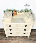 Off white painted dresser with black pulls. The Royal Damask stencil has been applied in brown on the top of the dresser.