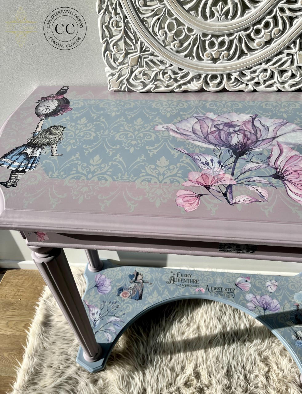 Blue and pink painted entryway table. The Alice Part 2 and Translucent Garden transfer have been applied to the table. The Royal Damask stencil has been applied to the table top also in white.