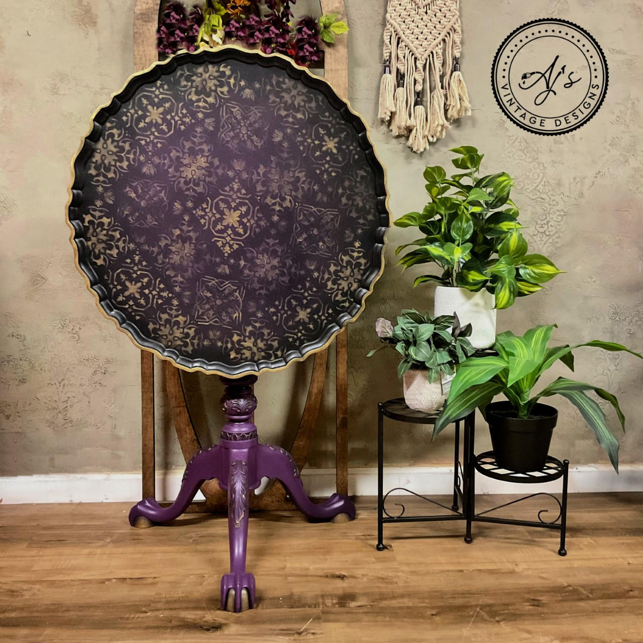 Belles and Whistles Sonoma Art Tile - Stencil provides an extra decorative touch to any project! A table that is standing vertical and is painted black with the sonoma art tile stencil.