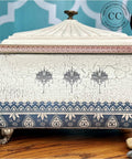 White painted jewelry box with silver feet. Crackle has been used with the paint to create a chippy, weathered look. The Bohemian Dream Transfer has been applied to the rim of the lid, the front, and on the bottom of the box.