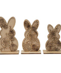 Three wooden bunny sculptures with intricate floral engravings. The rabbits vary in size, with the largest on the left and smallest on the right, each featuring detailed rose designs.