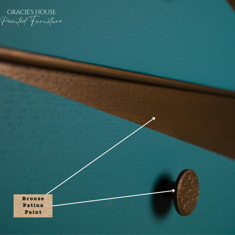 Dixie Belle Bronze Patina Paint. Close-up of a drawer featuring teal paint with a bronze patina finish. A round, textured bronze knob is visible. There's a label pointing to the painted surface, indicating "Bronze Patina Paint." The top left corner says "Gracie's House Painted Furniture.