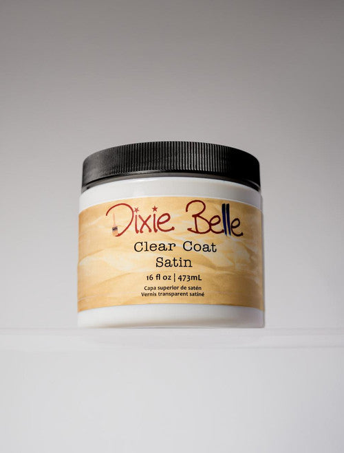 A container of Dixie Belle Clear Coat Satin, 16 fl oz (473 mL), with a black lid and a tan label, displayed against a neutral background.