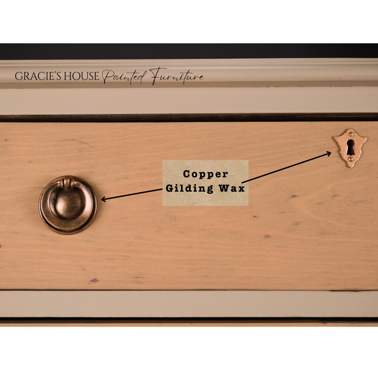 A wooden drawer shows a round metal handle and keyhole. Text labels point to these features: “Copper Gilding Wax” is indicated between the handle and keyhole. The drawer is part of Gracie’s House Painted Furniture collection.