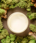 Overhead shot of Cucumber Ice paint jar. Staged with moss, pinecones, and mushrooms around it.