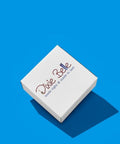 A white square box with the words â€œDixie Belle made right &amp; made to lastâ€ in script font, placed on a bright blue background with a shadow extending to the right.